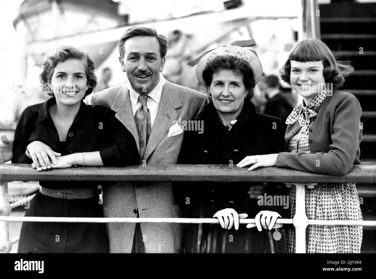 Britain Is 'Treasure Island' For The Disneys - Mr and Mrs. Walt Disney with daughters Diane (left) and Sharon (right) on arrival at Southampton. Accompanied by his wife and daughters - Diane, 16, and Sharon, 13 - Hollywood cartoon film producer Walt Disney arrived at Southamption aboard the Cunard-White Star liner 'Queen Elizabeth'. Disney, creator of Mickey Mouse, Donald Duck and a host of other cartoon characters, has come to Britain to make 'Treasure Island' (his first all-live film) at Denham. June 21, 1949. (Photo by Reuterphoto). Stock Photo