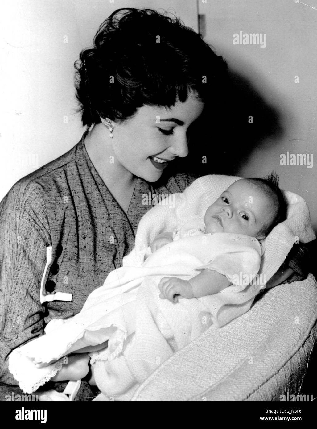 Hello, Mike! ... First pictures of Michael Howard Wilding, born January 6, 1953. Proud parents are M-G-M stars Elizabeth Taylor (soon to be seen, appropriately enough, in 'The Girl Who Had Everything') and English actor Michael Wilding. April 17, 1953. (Photo by G.J. Anstin). Stock Photo