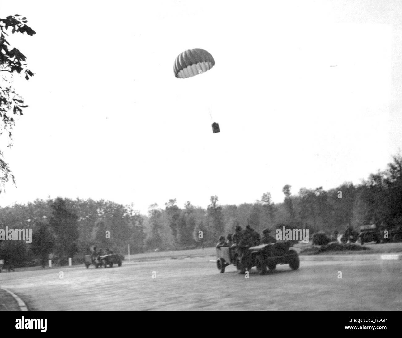 cture Of British Airbourne Forces In Holland -- A supply basket dropping on a ***** to be collected by airborne forces with jeeps. When the 1st., Allied the 1st. Allied Airbourne army was dropped in Holland, photographers of the Army Film and Photographic Unit were with them. This is one of the first photographs received back from them. One of the photographers writes in a letter dated Sep. 20th., 'This is the fourth day if fighting an camera work is almost of the question. All day we have been under shell, morter and machine gunfire. September 28, 1944. (Photo by British Official Photograph). Stock Photo