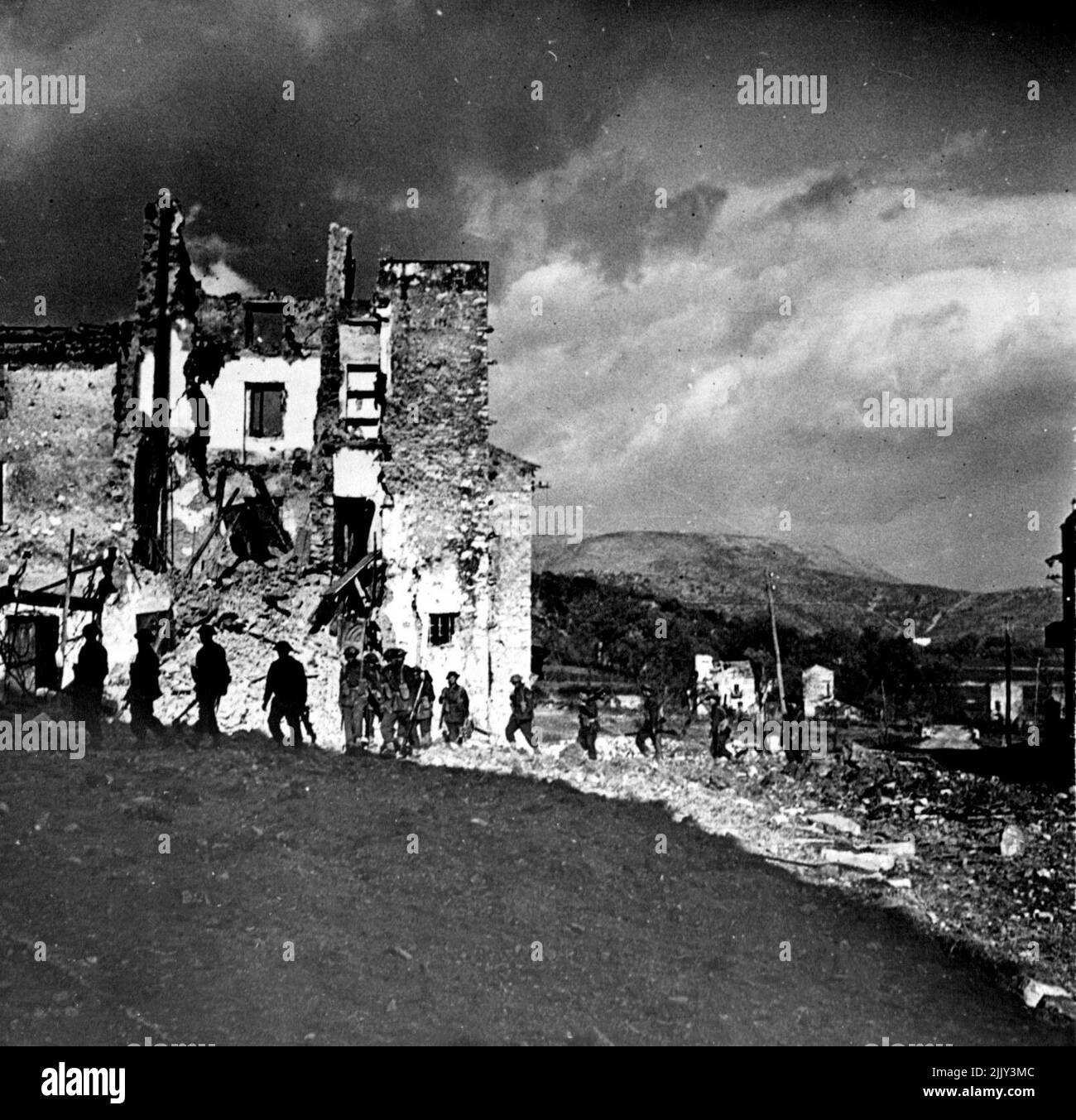 British infantry moving out of Lorenzo behind the tanks on a fighting