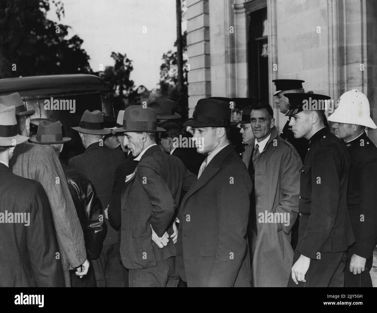 Raid on Parliament House, Brisbane (August 4). The raiders leaving Parlt. House under arrest. August 15, 1939. Stock Photo