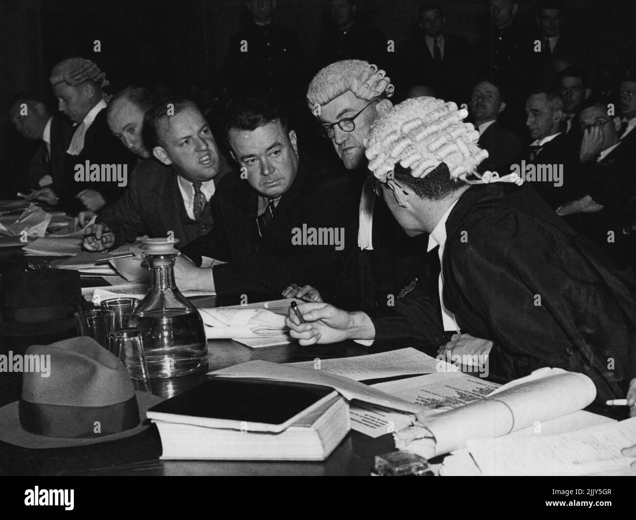 At The Bar Table This animated scene at the Bar table during the trial of 38 men in the Brisbane City Hall. Barristers, solicitors and police are in this group. October 11, 1939. Stock Photo