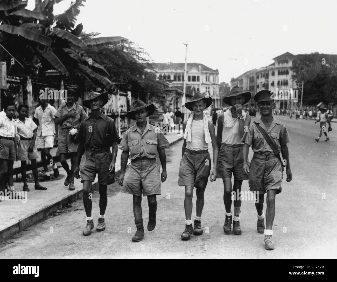 A happy band of 8th Australian Division ex-prisoners of war of the Japanese walking along Hill Street seeing the sights of the city for the first time in over three a half years. September 5, 1945. (Photo by Australian War Memorial Canberra). Stock Photo