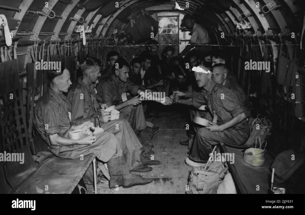 Aboard, the aircraft bound for Australia. A group of liberated Australian Prisoners of War are given food and cigarettes as they leave for home, The planes took off from the Civil Airport at Kalang in Singapore. September 22, 1945. (Photo by Netherlands Indies Information Service). Stock Photo