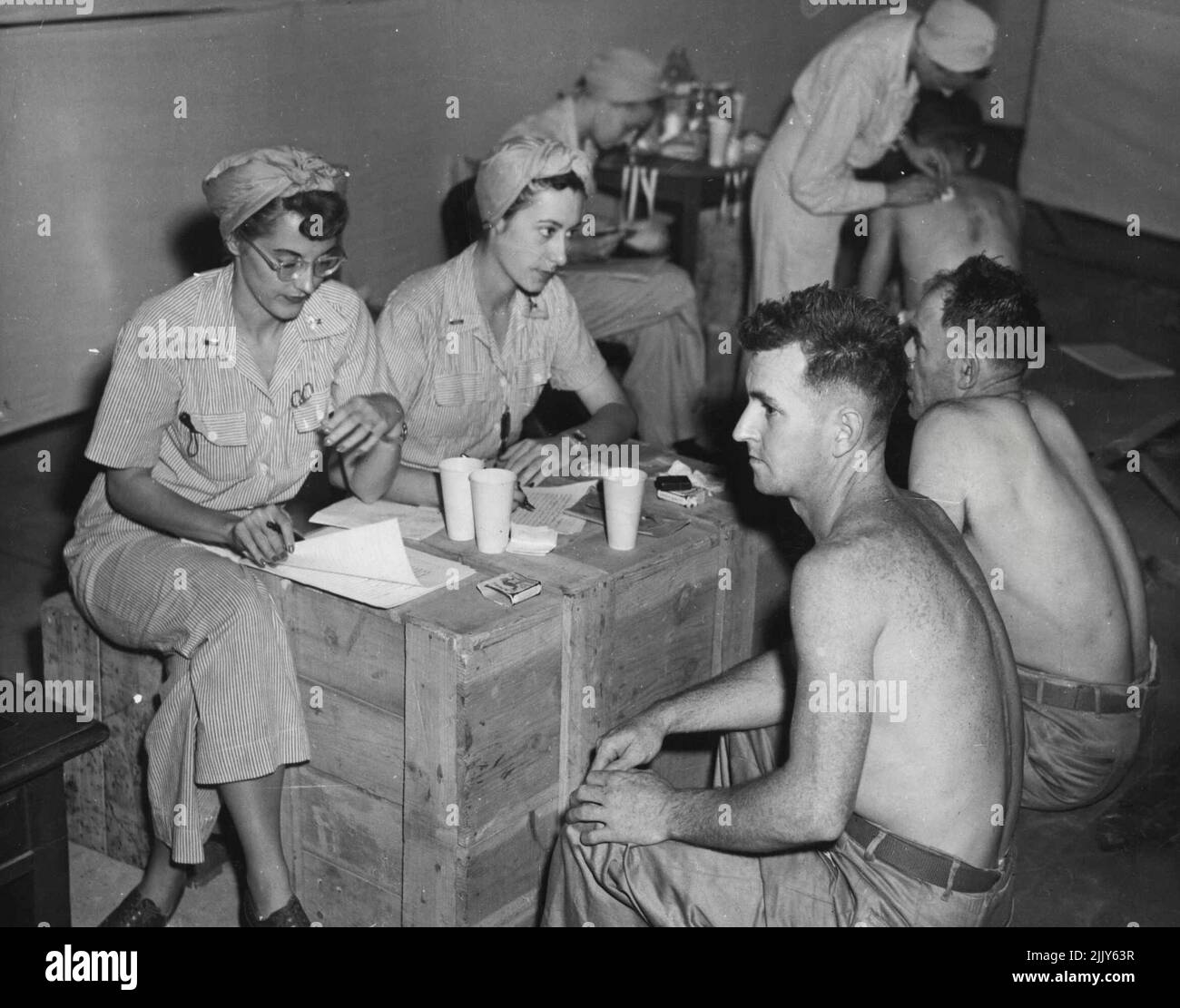 Released Eighth Division Prisoners-of-War receive comforts at a depot while awaiting medical attention from U.S. Army nurses in Yokohama. September 4, 1945. (Photo by Australian Official Photo). Stock Photo