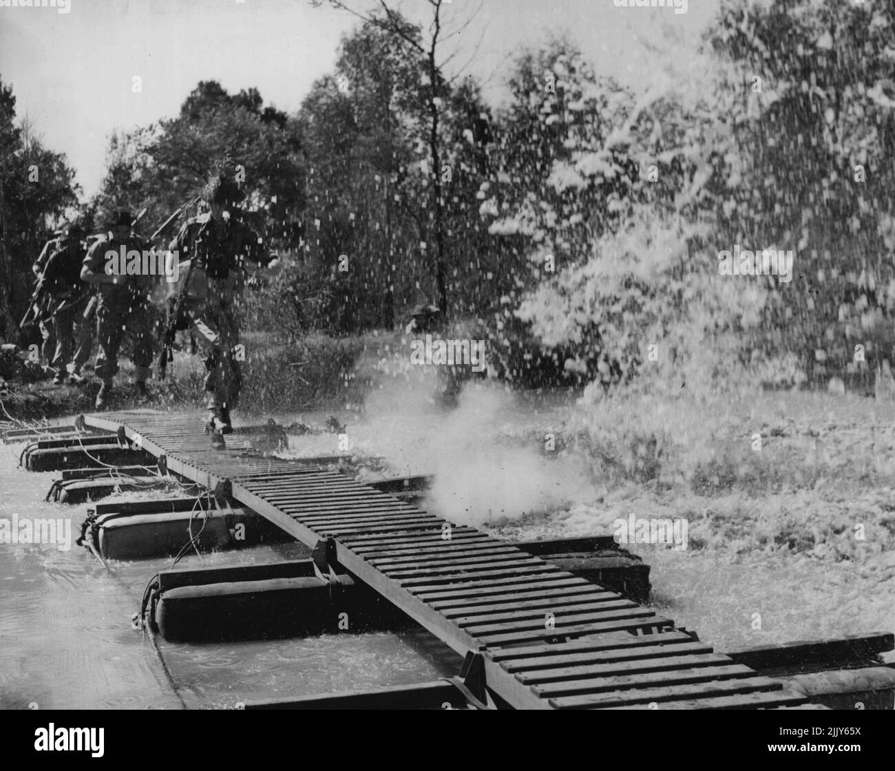 Korea Force - Several shots of gelignite exploding alongside the pontoon bridge they are crossing provide plenty to course. September 13, 1950. Stock Photo