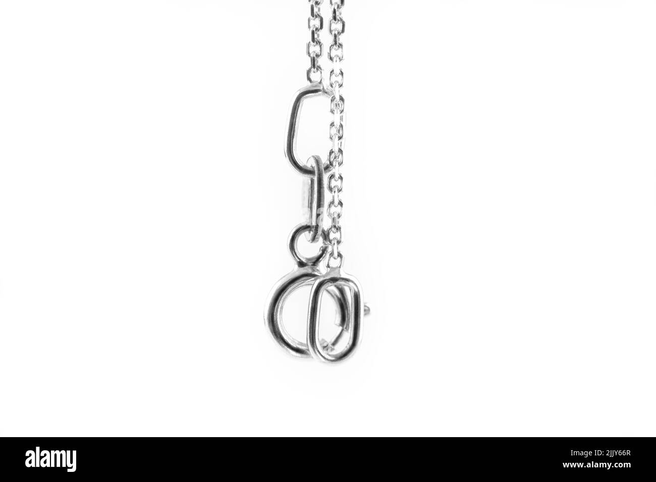 Silver chain hanging on a white background Stock Photo Alamy