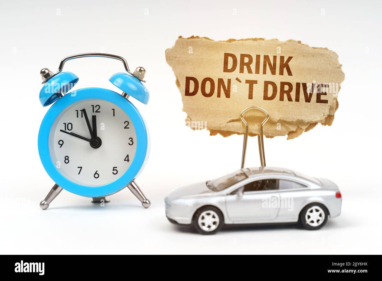 Transport concept. On a white surface there is a blue alarm clock, a