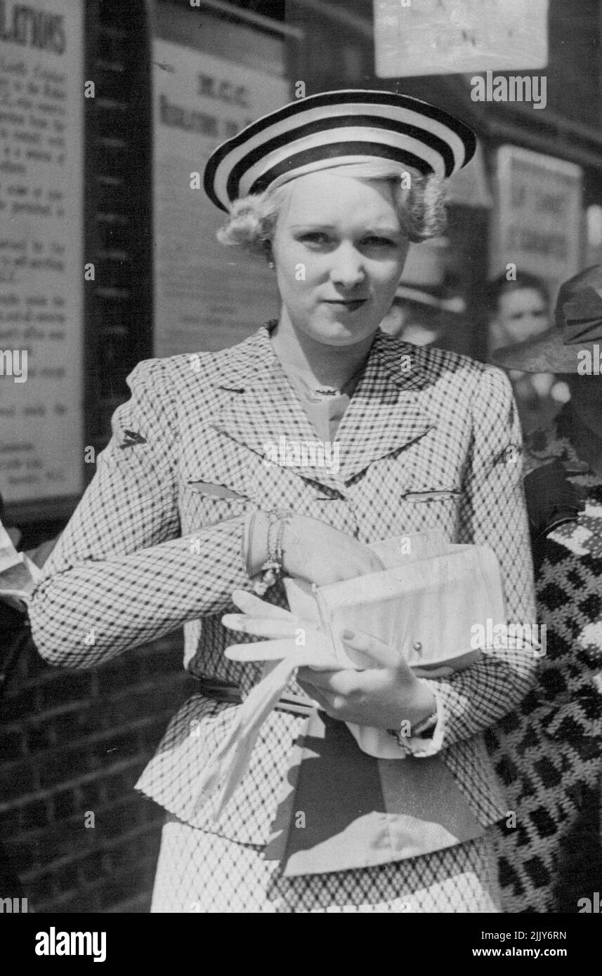 The Eton V. Harrow cricket match at Lord's is noted as a rendezvous for fashionable London. This smart outfit, with striking rainbow hat, was worn by Lady Iris Mountbatten. A fashionable young lady, she was seen at all the best places with proper escorts. December 17, 1952. Stock Photo