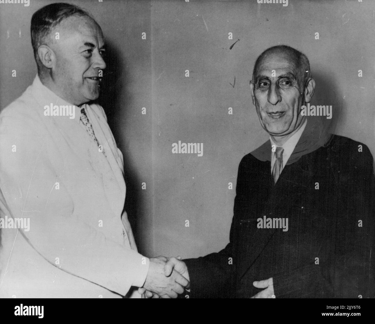 Stokes Meets Mossadeq -- Richard Stokes, British lord privy seal, who is leading the British mission in oil negotiations with the Persian government, shakes hands with premier Mossadeq (right) of Persia, as the ***** meet for the first time first time, in Tehran a few days ago. August 21, 1951. (Photo by Associated Press Photo). Stock Photo