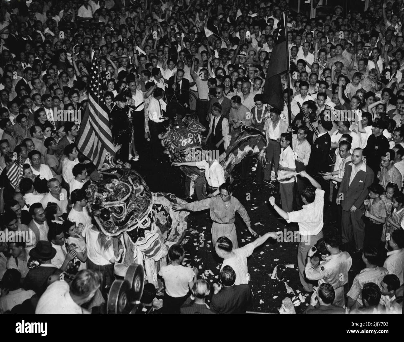 Dragon Dance In New York Chinatown -- Two dragon-like images begin te sacred dragon dance, reserved for the Chinese new year, in New York’s Chinatown, August 14, after news of the Japanese capitulation was received. August 14, 1945. (Photo by Associated Press Photo). Stock Photo