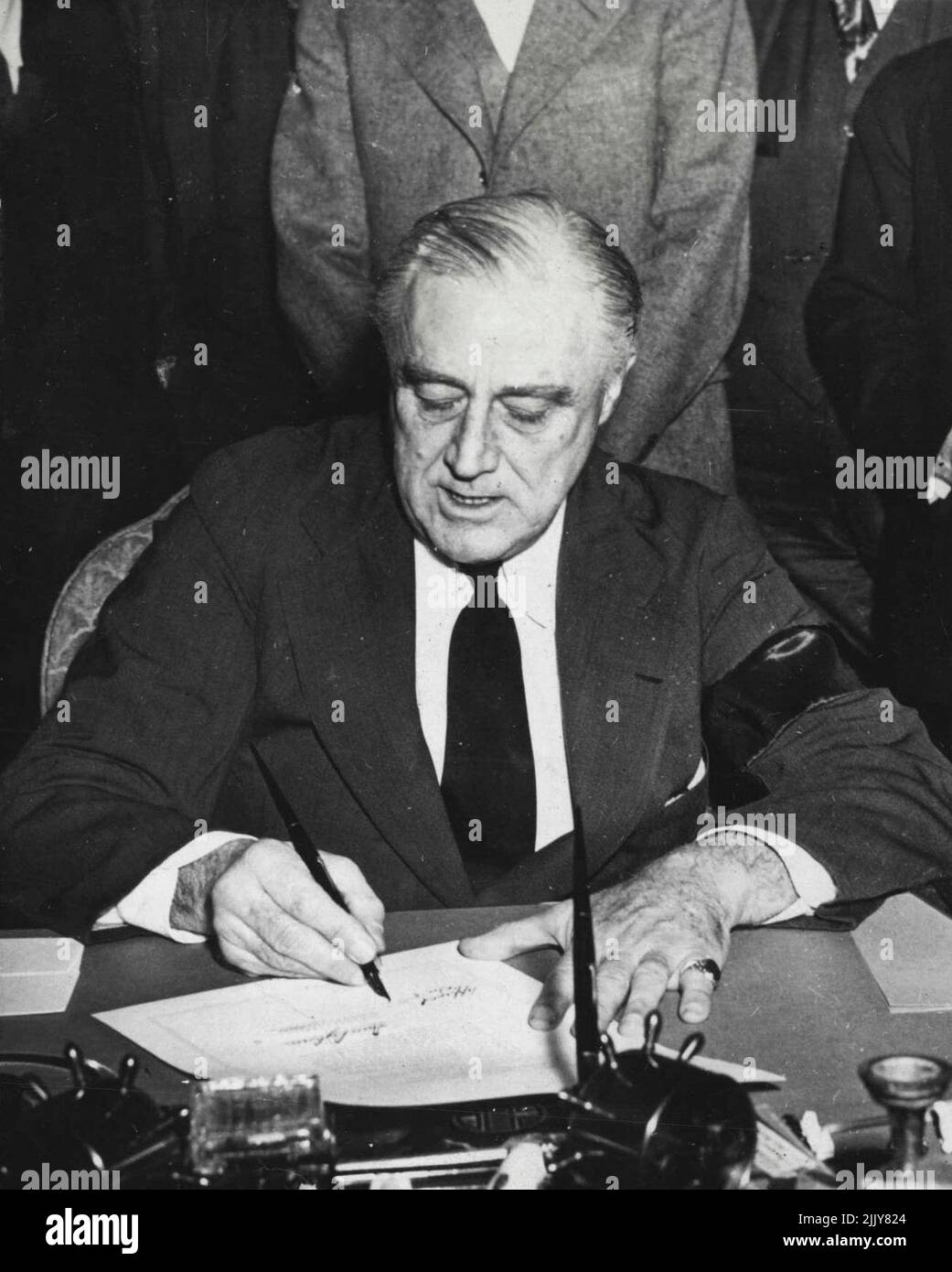 sevelt signs the declaration of war on Japan they day after Japanese forces attacked Pearl Harbor, Hawaii, on December 7, 1941. He was wearing a mourning band for his mother, the late Mrs. Sara Delano Roosevelt. In accepting the Democratic Party's renomination for the U.S. Presidency on July 20, 1944, President Roosevelt stated that one of the tasks before America in 1944 is to'....form world-wide organizations and to arrange to use the armed force of the sovereign nations of the world to make be the Republican Party's nominee. April 14, 1945. (Photo by U.S. Office of War Information Picture). Stock Photo