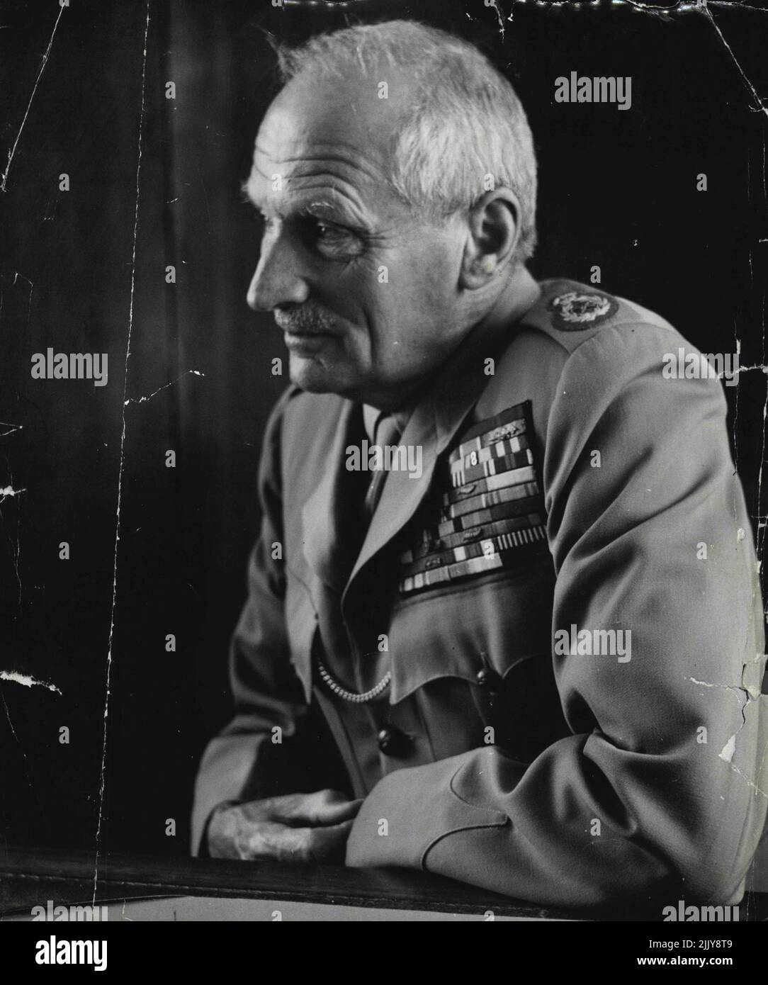 Field Marshal Montgomery -- Field Marshal Montgomery in his austere like office at supreme H.Q. at Shape H.Q. The walls are dark oak panelling completely unadorned except for a single map of Europe. His desk is the essence of tidyness and not a single paper is out of place or for that matter not one can be seen. Lord Montgomery 'whole thing muddled up'. January 08, 1954. (Photo by Jack Esten). Stock Photo