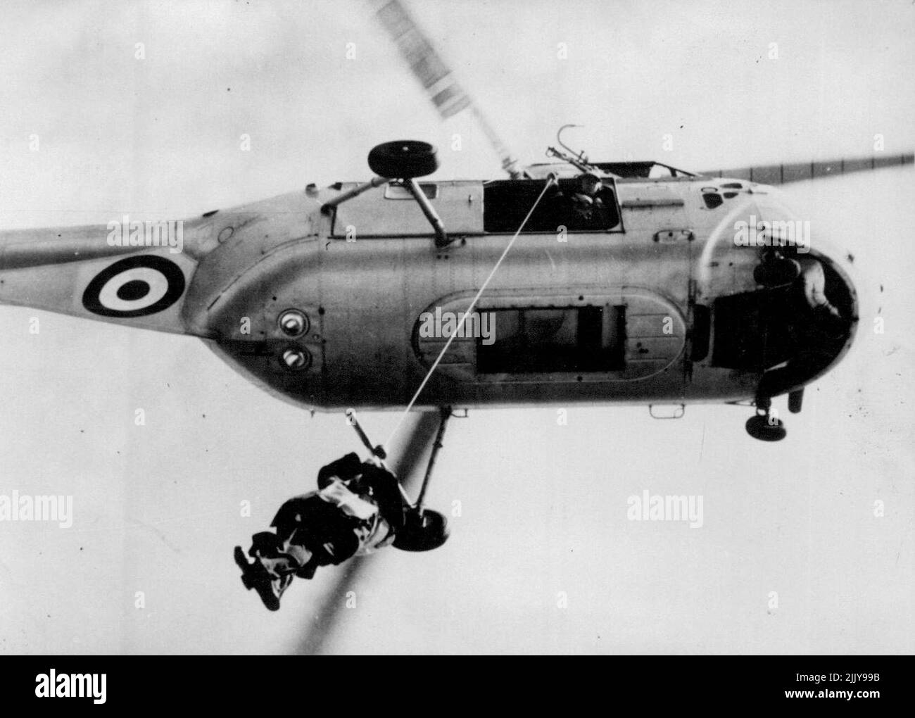 Admiral Mountbatten Uses The Modern Method - Admiral the Earl Mountbatten, C-In-C. Mediterranean Fleet, being hauled up into a helicopter when he left the cruiser H.M.S. 'Glasgow' recently for a journey ashore. Transfer from ship to ship or ship to shore by mean of helicopters is rapidly becoming the routine in the Royal Navy. Because of the speed and efficiency of this method, many senior officers prefer the helicopter to the Admiral's 'Barge'. June 26, 1953. (Photo by Sport & General Press Agency, Limited) Stock Photo