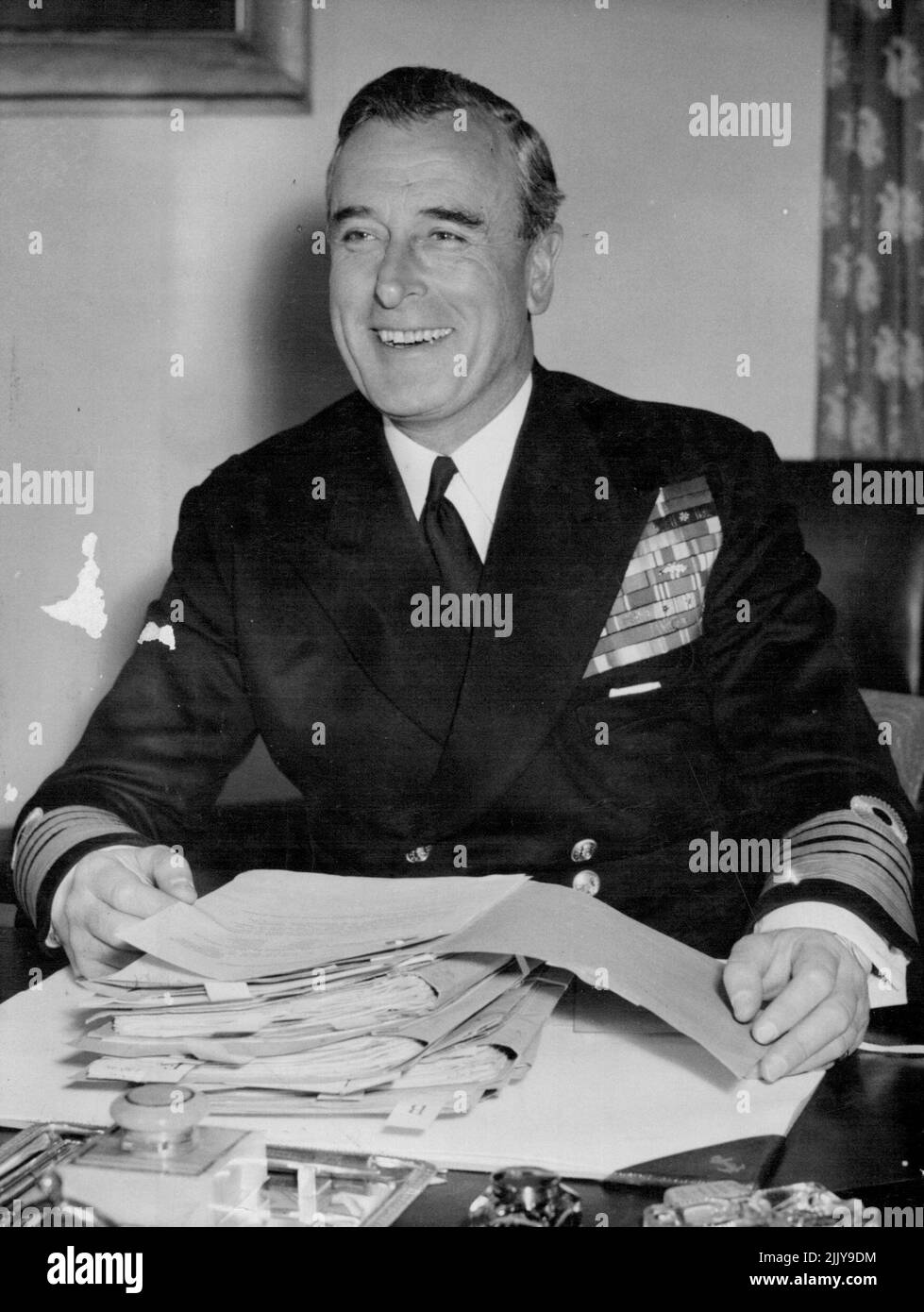 The New First Sea Lord -- Admiral Earl Mountbatten, who took over as first Sea Lord April 19, photographed for the first time in full uniform at his new dusk in the admiralty, London, today April 22. April 22, 1955. (Photo by Associated Press Photo). Stock Photo