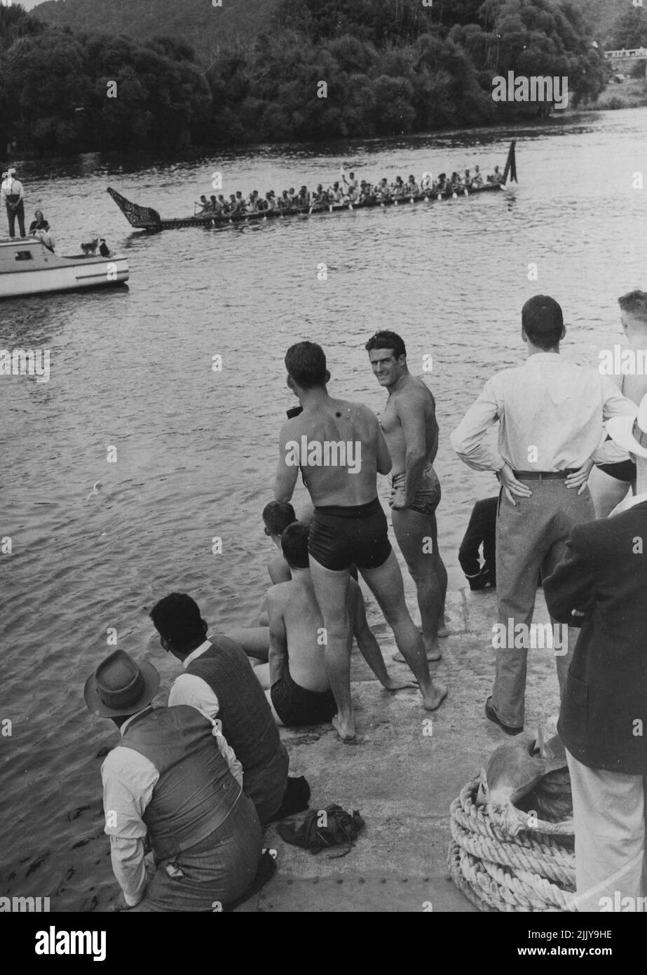 Members of the Australian Team watching a Maori war canoe. February 22, 1950. Stock Photo