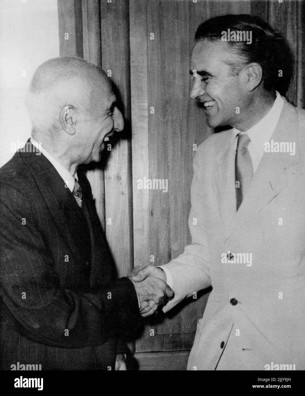 Mossadeq Shakes Hands With Truman's Rep -- Premier Mossadeq of Persia shakes hands with Mr. W. Averell Harriman, special representative of the president of the United States, soon after the latter's arrival for talks on the oil crisis. July 18, 1951. (Photo by Associated Press Photo). Stock Photo