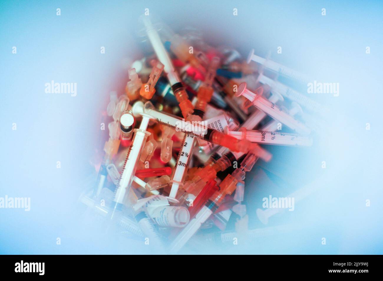 Syringes used for the monkeypox vaccine are seen inside of a bucket in a drive-through monkeypox vaccination point at the Westchester Medical Center in Valhalla, New York, U.S., July 28, 2022. REUTERS/Eduardo Munoz Stock Photo