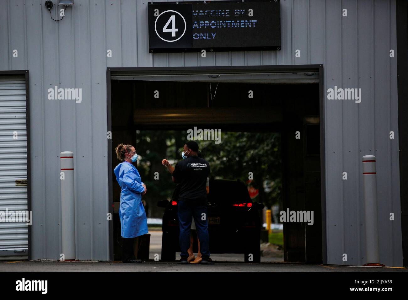Staff members of the Westchester Medical Center await the arrival of people to be vaccinated with monkeypox vaccine in a drive-through point at the Westchester Medical Center in Valhalla, New York, U.S., July 28, 2022. REUTERS/Eduardo Munoz Stock Photo
