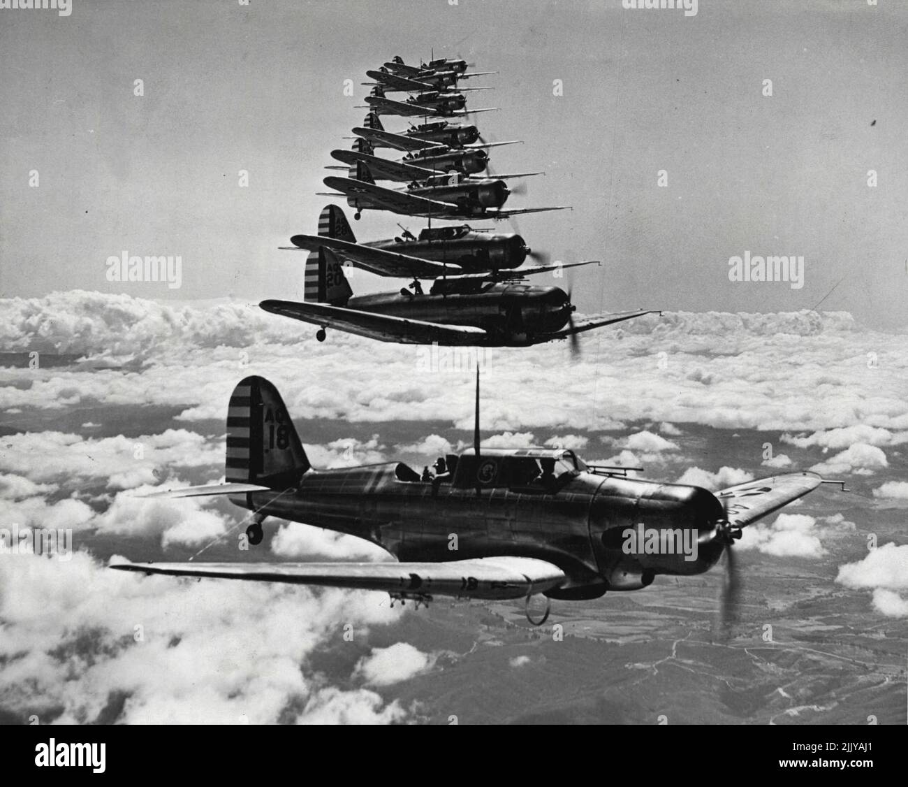 th Attack Group of the First Wing, G.H.Q. Air Force, shown executing a difficult precision formation high above the clouds during a cross country training flight recently. The formation is being led by Captain Robert F. Tate. President Roosevelt yesterday declared a 'National emergency' because of the European War, and issued orders for substantial increases in the Army, Navy, Marine corps, and National Guard. A former wartime pilot yesterday began a search of New Guinea's Markham Valley for the dive bomber in which he was shot down 25 years ago. September 9, 1939. (Photo by Wide World Photo). Stock Photo