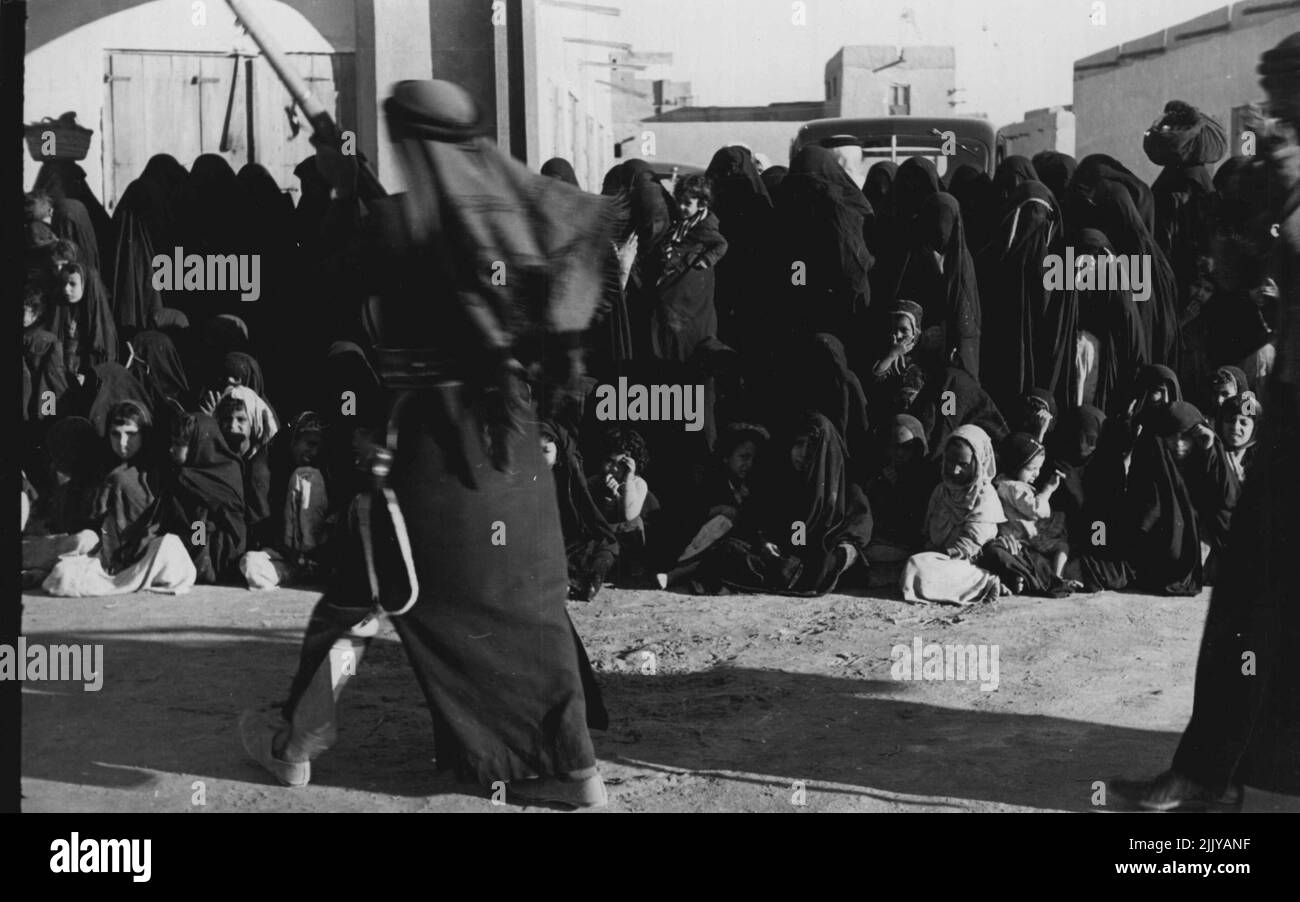 Bedouin Dance In Kuwait. Womenfolk, shrouded in black and hiding
