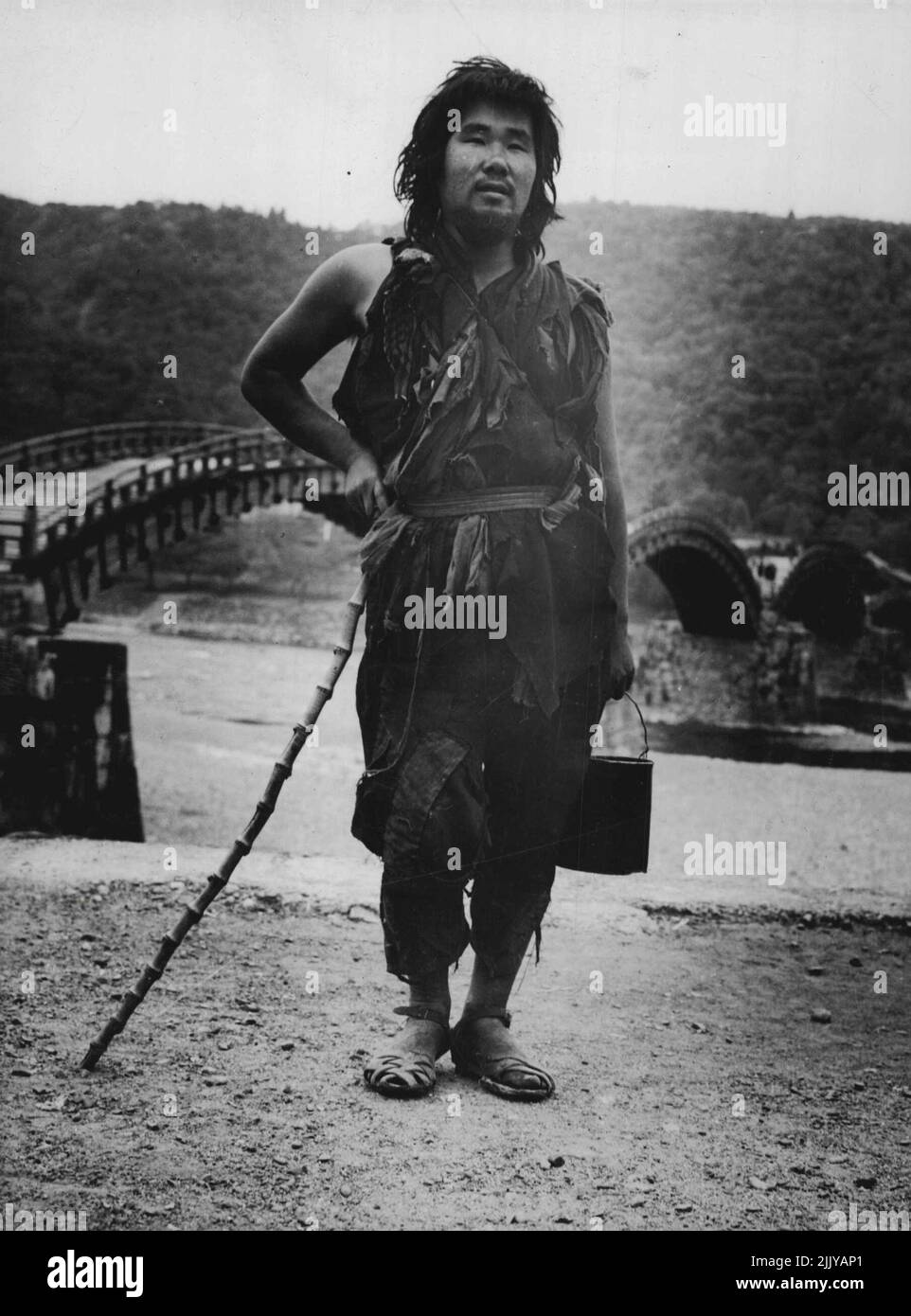Japanese Tramp poses near famous Iwakuni Bridge. June 20, 1950 Stock