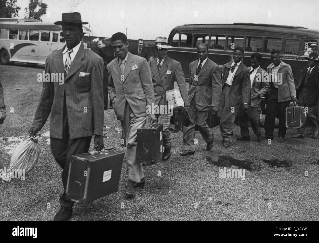 Looking For Work -- The immigrating Jamaicans landing to go to the special coaches which were taking those without friends to London to spend their first ***** in the ***** shelters at Clapham. The emigration in reverse has brought nearly 500 Jamaicans to England. They arrived early this morning aboard the liner Empire Windrush, and hope to find work in England - some will rejoin the RAF, some will work as miners, many are ***** technicians, they all hope for the work here they cannot find in their own country. June 22, 1948. Stock Photo