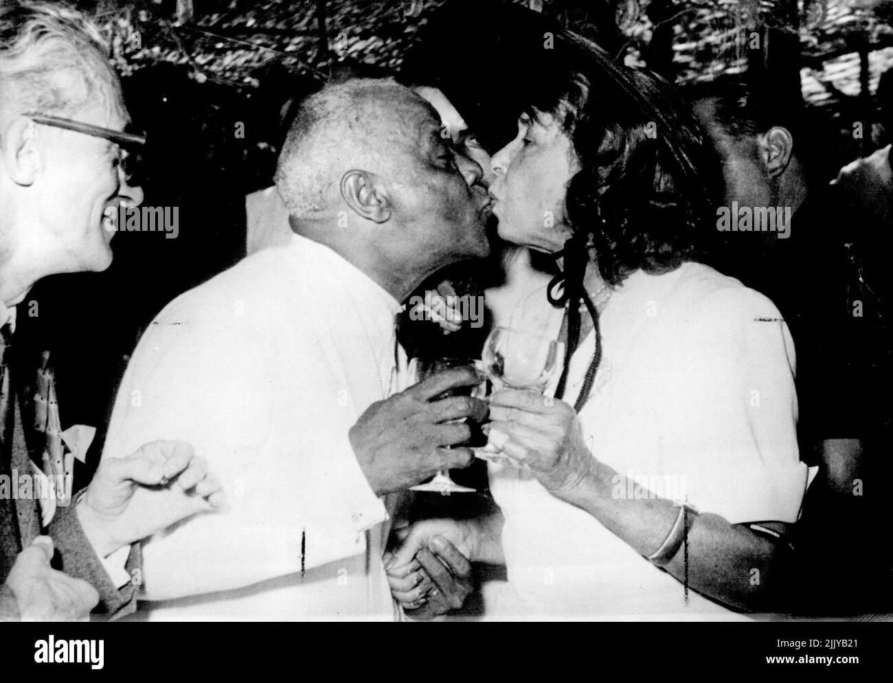 23 Years Engaged - Now Married - Mistinguett Congratulating the Bridegroom with a kiss on the mouth. The well-known Clarinettist Sidney Bechet married his fiancee to whom he engaged for 23 years, Miss Yvonne Ziegle, at antibes, France on Aug 17. The Marriage was celebrated in'New Orleans style' with a procession winding its way through the town?. August 20, 1951. (Photo by Paul Popper). Stock Photo