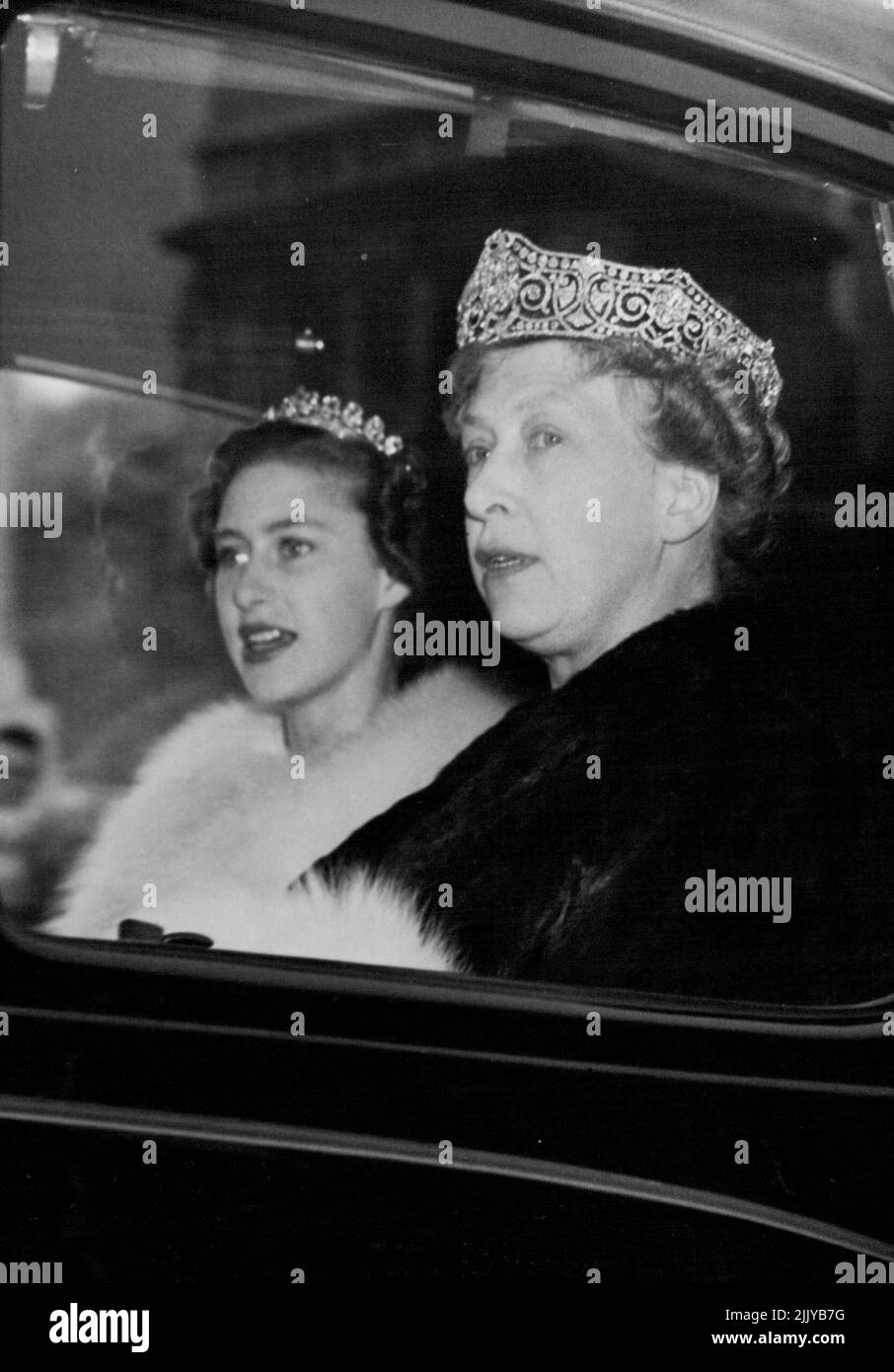 Princess Margaret And The Princess Royal -- Princess Margaret and The Princess Royal are pictured here at horse guards parade in a Maroon Daimler car en route to the houses of parliament this morning November 4 for the state opening of parliament by the queen. November 27, 1952. (Photo by The Associated Press Ltd.). Stock Photo