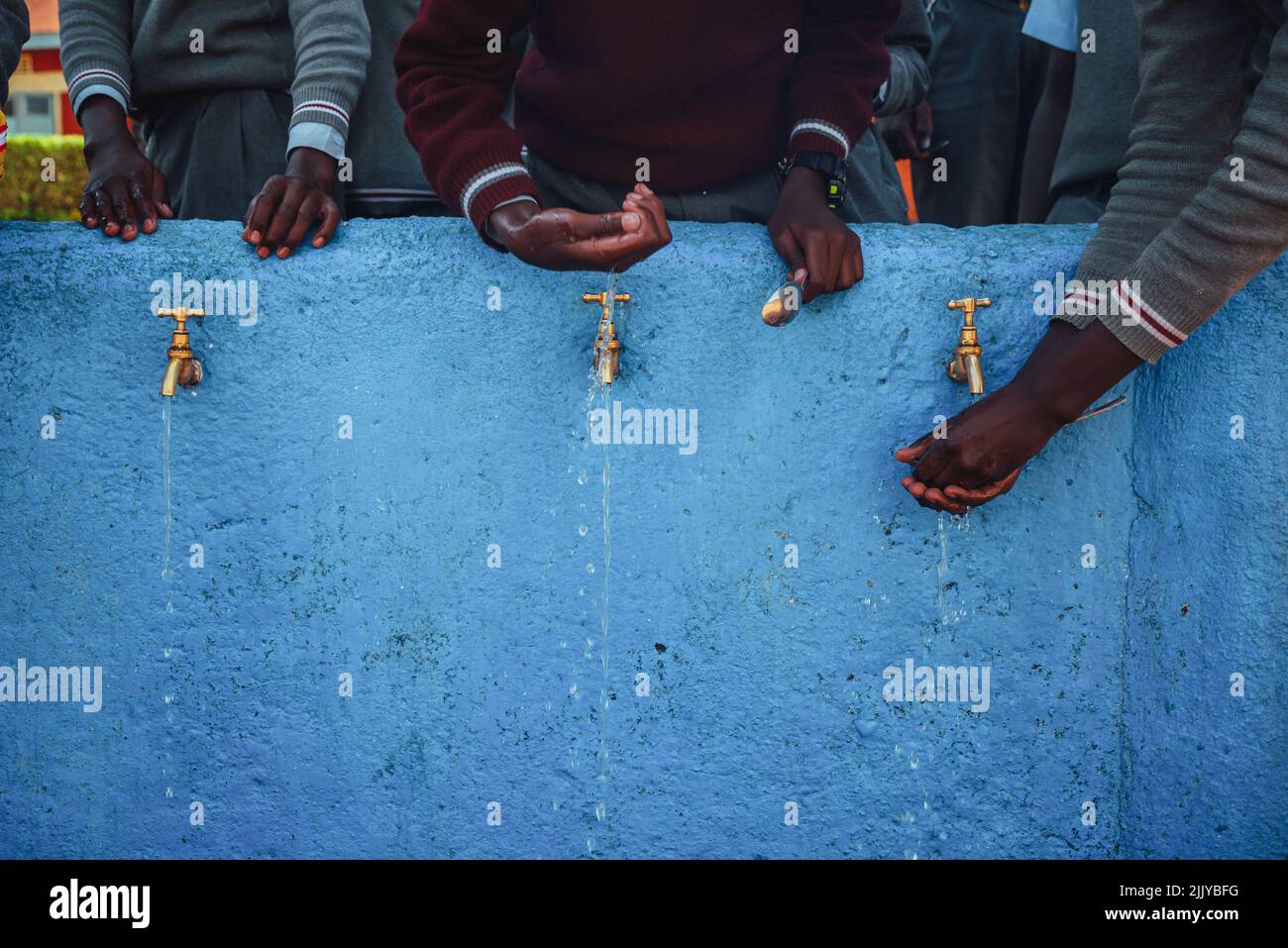 Lack of Water in Africa. African children holding hands by source of water. Illustration photo. Drought in Africa Stock Photo