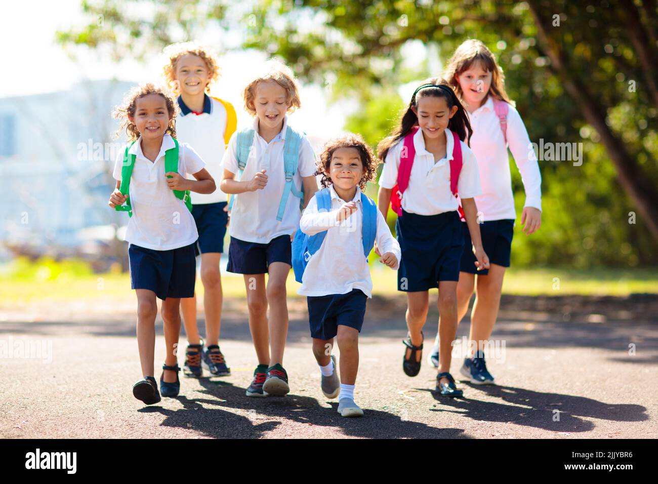 Kids go back to school. Interracial group of children of mixed age run