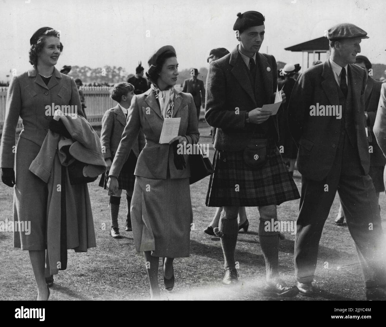 Two escorts for Princess ***** At Scottish Race Meeting With Princess Margaret at the Hunt races in Scotland yesterday were kilted Lord Ogilvy. son and ***** of the Earl of Airlie, and (wearing cap) the Earl of Dalkeith, heir to the Duke of Buccleuch. The Princess wore a dusty-pink lightweight suit and a silk hand-painted scarf. September 20, 1950. (Photo by Paul Popper Ltd). Stock Photo