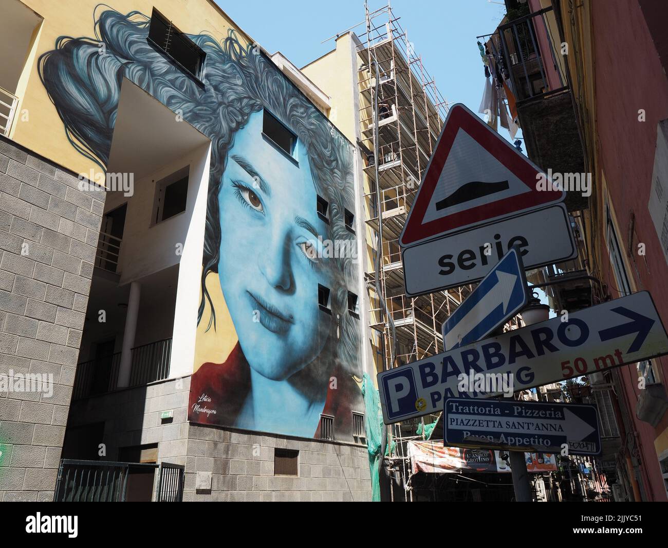 Large mural with portrait of a woman in blue, in the city center of Naples, Campania, Italy Stock Photo