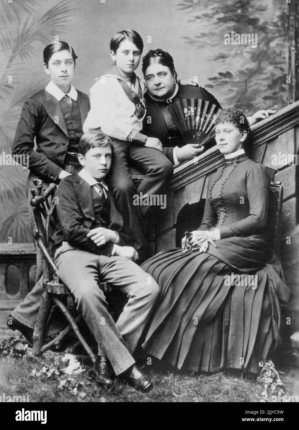 When Queen Mary Was Princess Victoria Mary -- A Picture made about 1885, showing the Princess Mary, Duchess of Teck, with her four Children. At the right, seated is Princess Victoria Mary, then Eighteen, who is now Queen Mary of England. The other children are the Late Marquis of Cambridge; the Late Princess Francis of Teck; and his Royal Highness, the Earl of Athlone. May 05, 1935. (Photo by International News Photo). Stock Photo