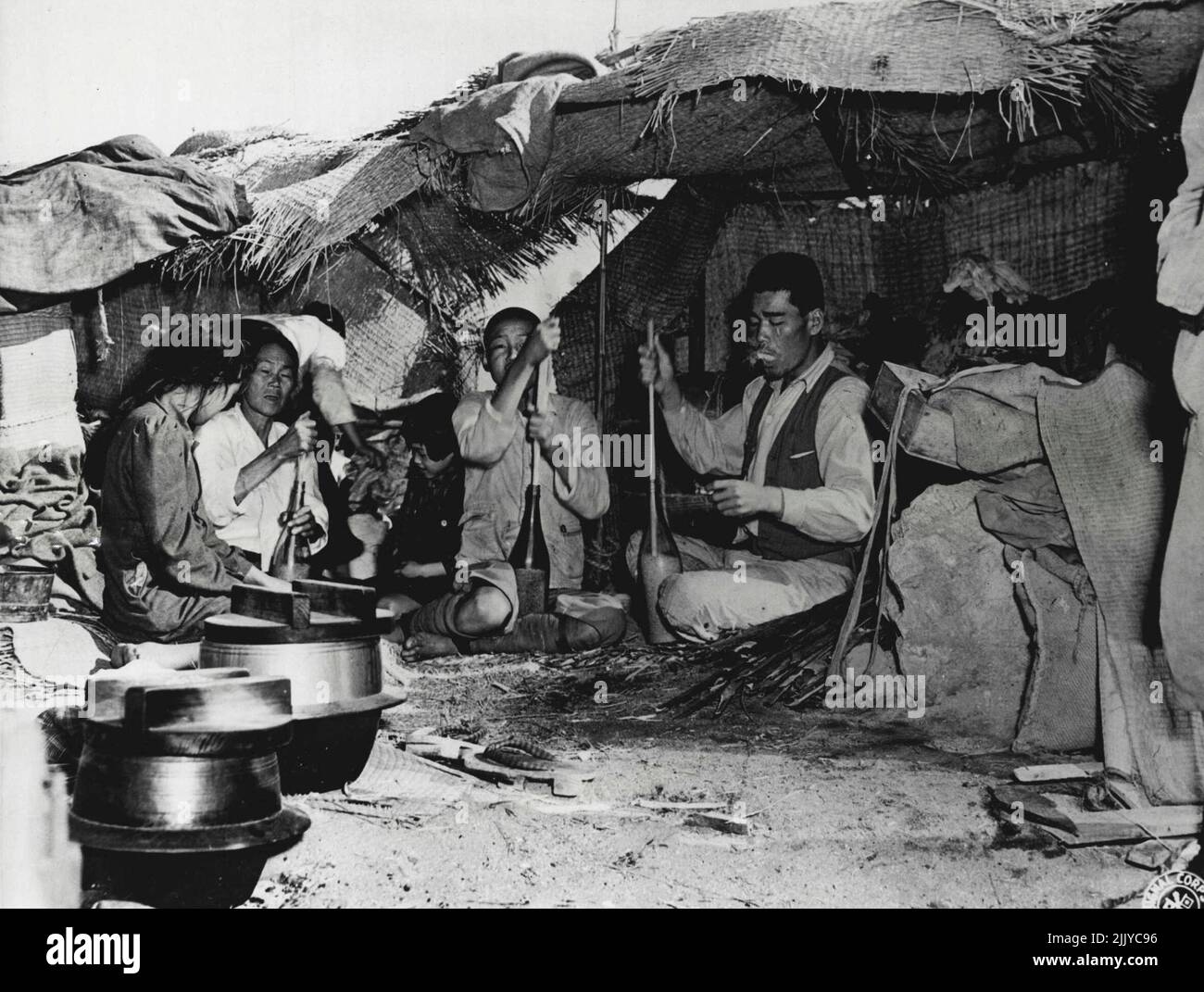 Polishing rice in a bottle, a Korean Laborer and his family are shown ...