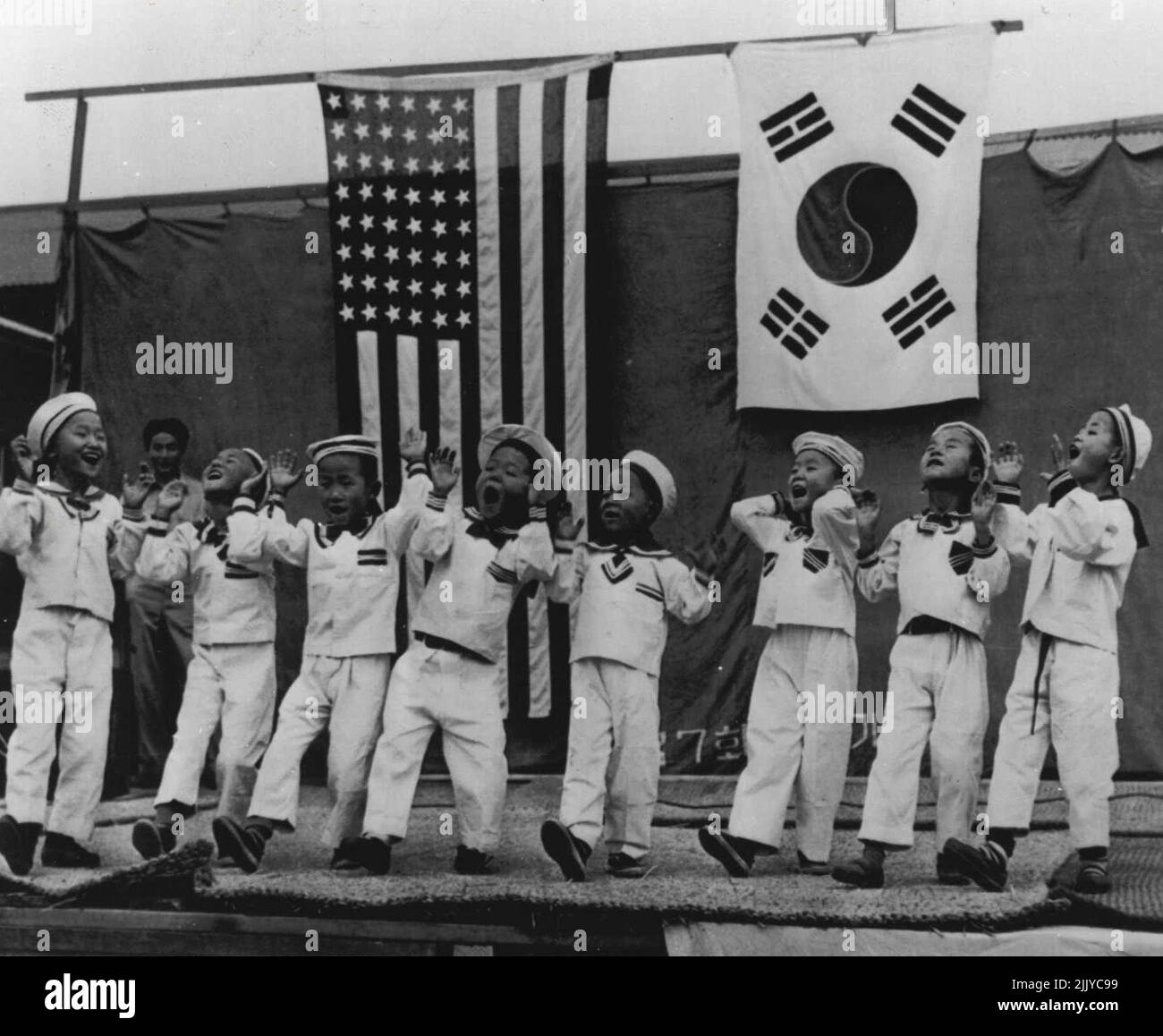 Help Youngsters -- These Korean youngsters find pleasure in their song and dance routine as they entertain U.S. Marines during dedication of the Bong Ill Chon Primary School in Korea. school is one of 14 projects sponsored by Marines under the Armed Forces Assistance to Korea program. November 20, 1954. (Photo by AP Wirephoto). Stock Photo