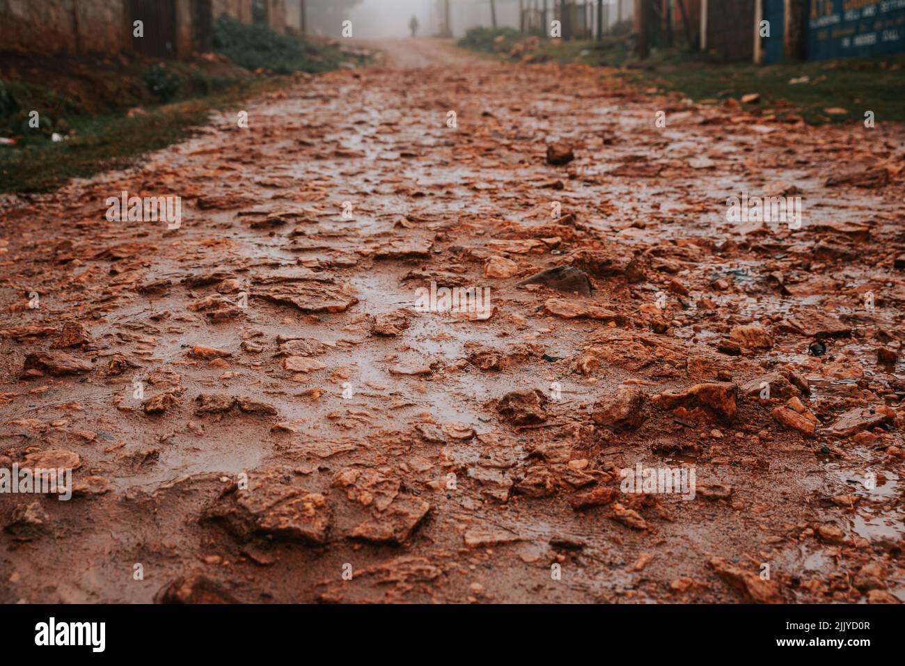Rough red dirt roads in kenya where Kenyan runners and marathon runners run Stock Photo