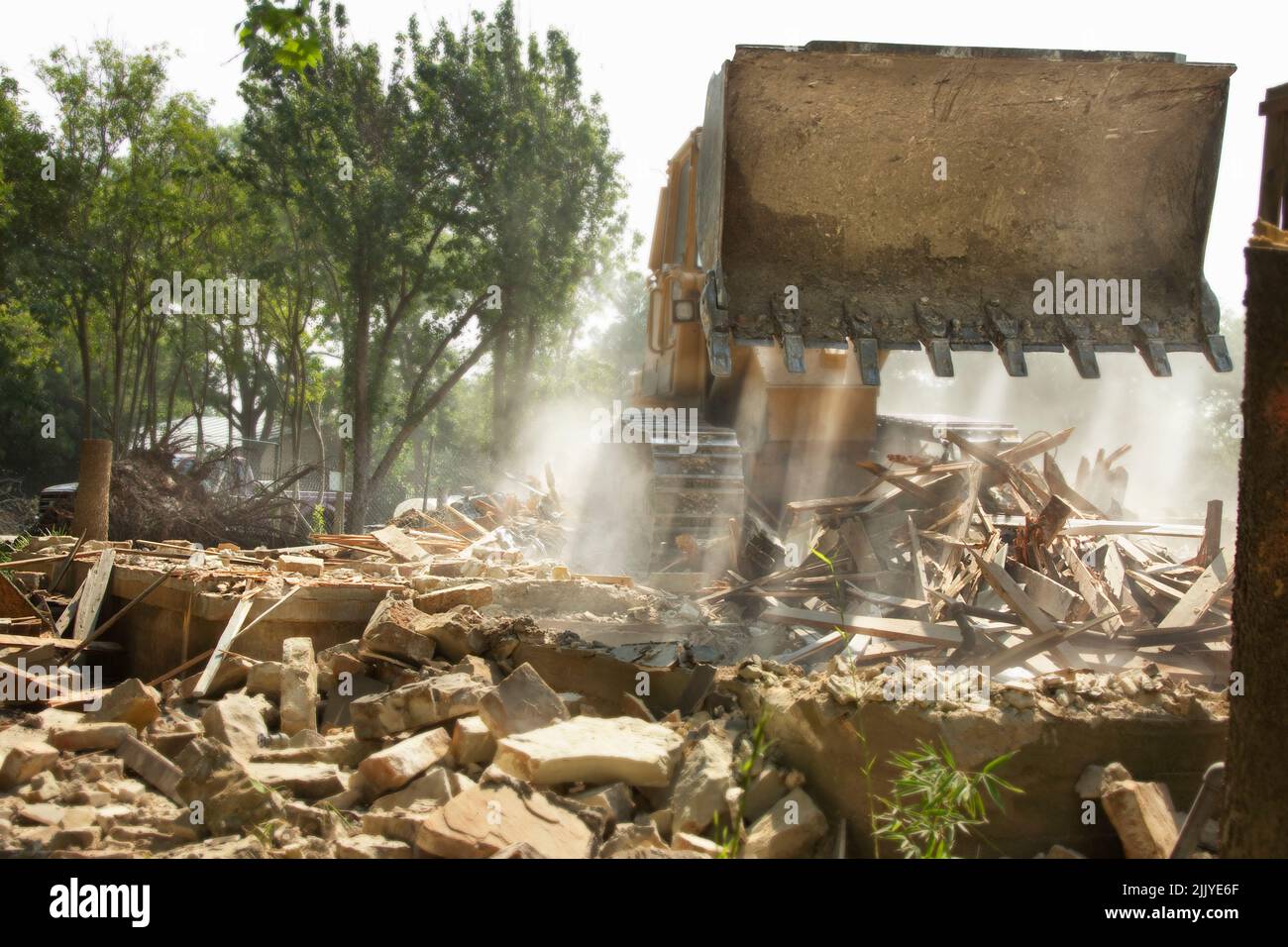 Demolition of residential home with bulldozer preparing for new construction Stock Photo