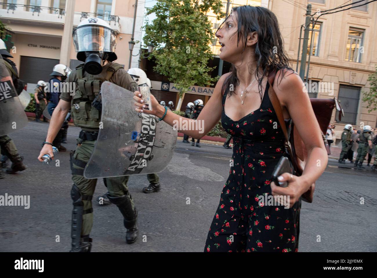 Athens, Greece. 28th July, 2022. Protesters try to run away from police tear gassing them and hitting them with batons and the water cannon. Thousands took to the streets to protest over the government's failure to deal with wildfires as well as show their solidarity with political prisoner Giannis Michailidis who has been on hunger strike since may 23rd. (Credit Image: © Nikolas Georgiou/ZUMA Press Wire) Stock Photo