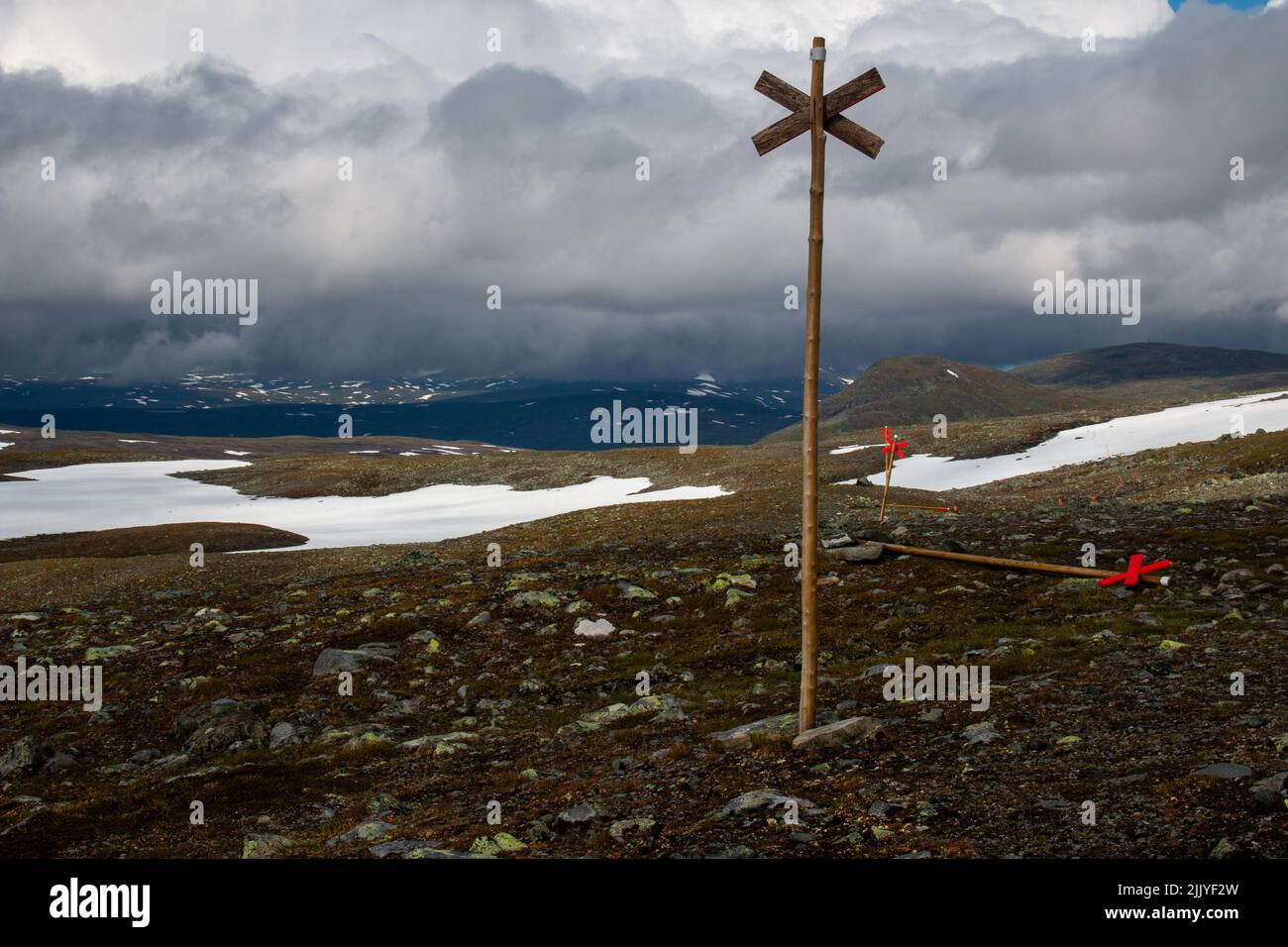 Snow patches on a hiking trail to Sylarna Mountain Station in the rain, July, Jamtland, Sweden Stock Photo