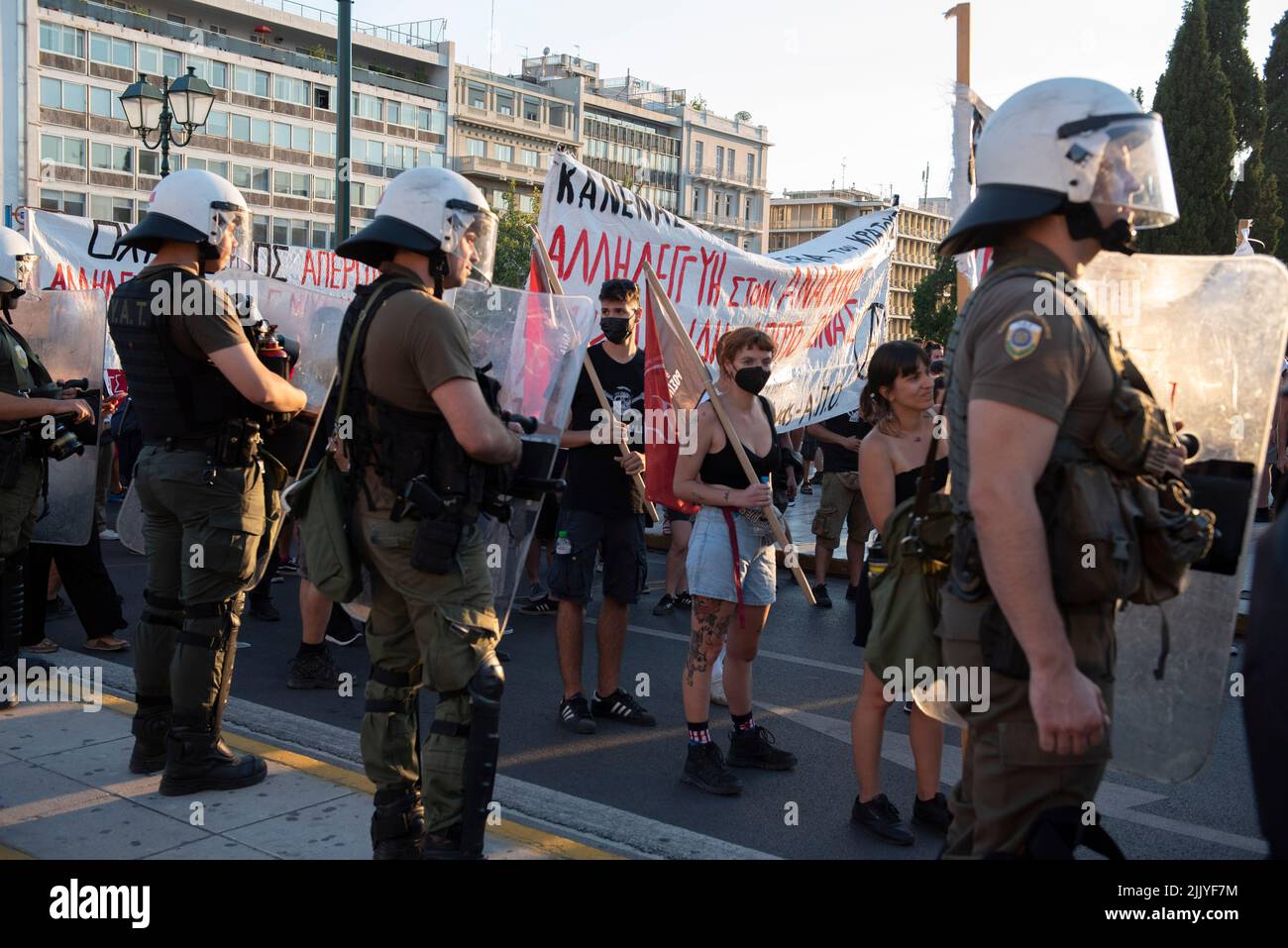 Athens, Greece. 28th July, 2022. Protesters try to run away from police tear gassing them and hitting them with batons and the water cannon. Thousands took to the streets to protest over the government's failure to deal with wildfires as well as show their solidarity with political prisoner Giannis Michailidis who has been on hunger strike since may 23rd. (Credit Image: © Nikolas Georgiou/ZUMA Press Wire) Stock Photo