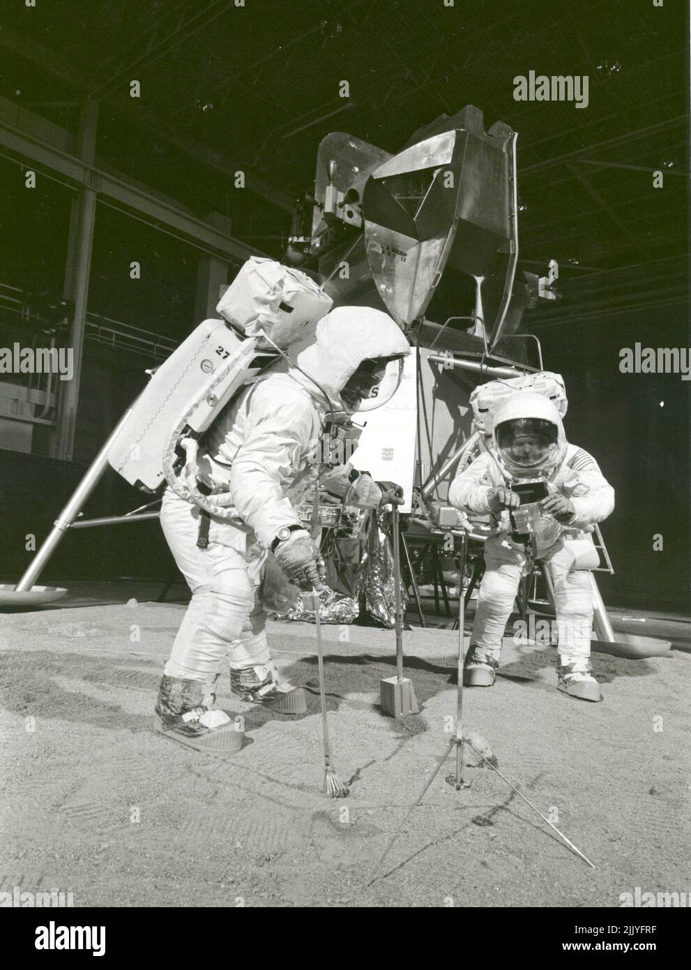 Usa. 22nd Apr, 1969. Two members of the Apollo 11 lunar landing mission participate in a simulation of deploying and using lunar tools on the surface of the Moon during a training exercise on April 22, 1969. Astronaut Buzz (Aldrin Jr. on left), lunar module pilot, uses a scoop and tongs to pick up a soil sample. Astronaut Neil A. Armstrong, Apollo 11 commander, holds a bag to receive the sample. In the background is a Lunar Module mockup. Credit: NASA/ZUMA Press Wire Service/ZUMAPRESS.com/Alamy Live News Stock Photo