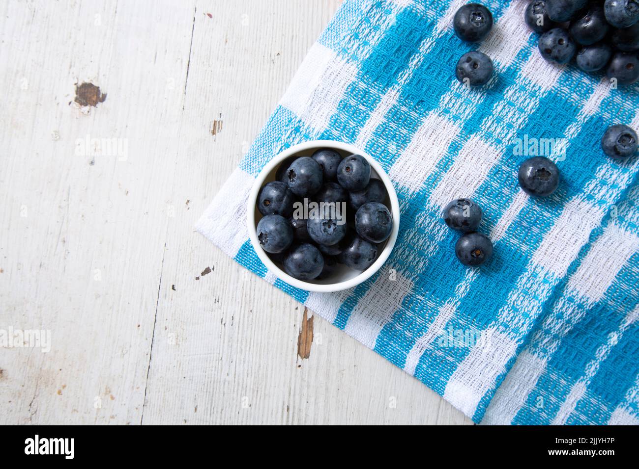 Top view of blueberries in a small bowl on a wooden table Stock Photo