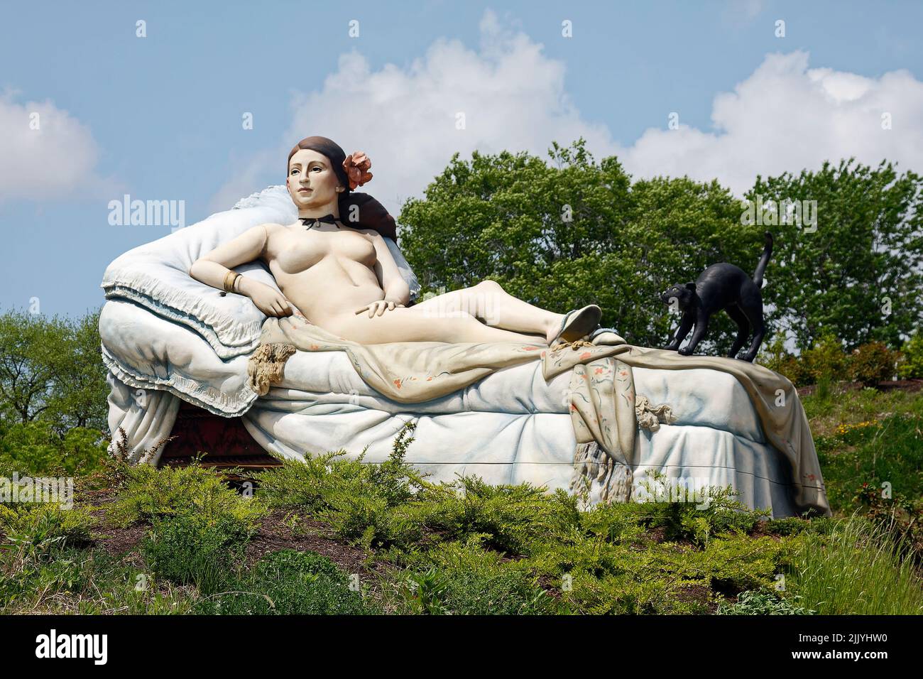 Confrontational Vulnerability, styrofoam sculpture; by Seward Johnson; large sculpture, 2011, nude woman reclining, black cat, Grounds for Sculpture; Stock Photo