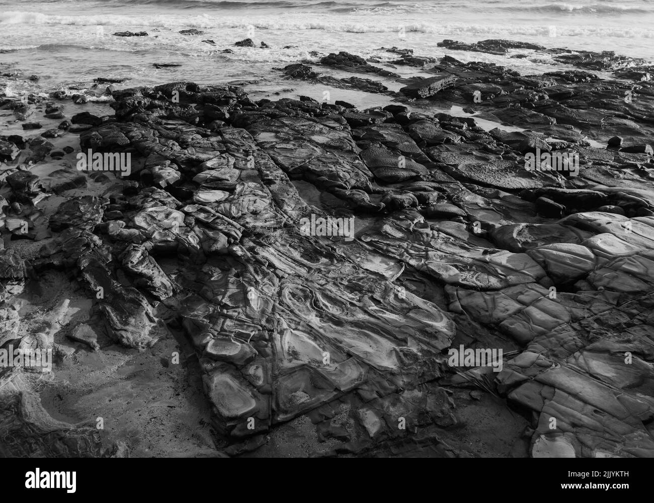 Beach rocks gentle waves Black and White Stock Photos & Images - Alamy