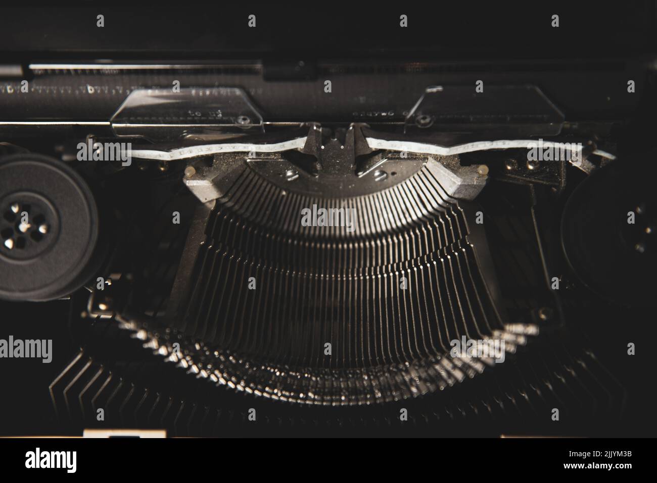 Typewriter typebars and black and white ink tape Stock Photo - Alamy