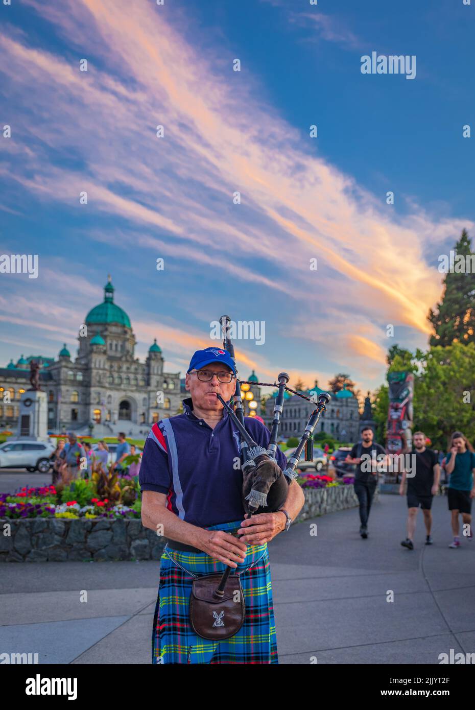 Bagpiper in Victoria BC. Scottish bagpiper dressed in traditional tartan dress playing bagpipers-July 20,2022-Canada-Travel photo, street view Stock Photo