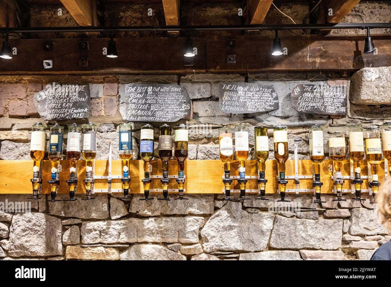 Oban distillery for scotch whisky in Oban, interior bar with various whiskies on display for tasting,Scotland,UK Stock Photo