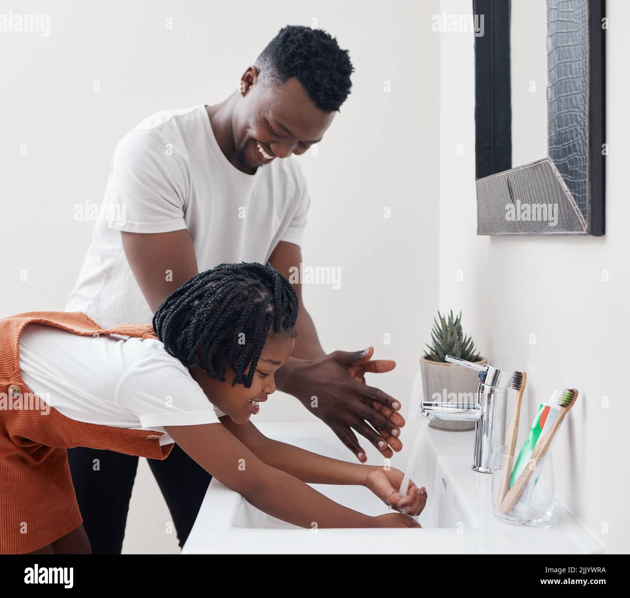 Teaching her the importance of hygiene. a young father helping his