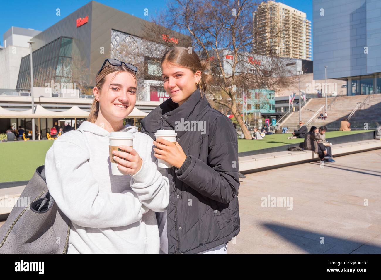 July 29, 2022 Chatswood, Sydney, Australia:  Finally some sunshine! Smiles all round from Lily and Lucy in Chatswood, Sydney as they enjoy their coffee and the morning sun. After what seems like weeks of flooding rain and constant downpours, sunny weather is predicted for Sydney over the coming weekend. Photo credit Stephen Dwyer Alamy Live News Stock Photo